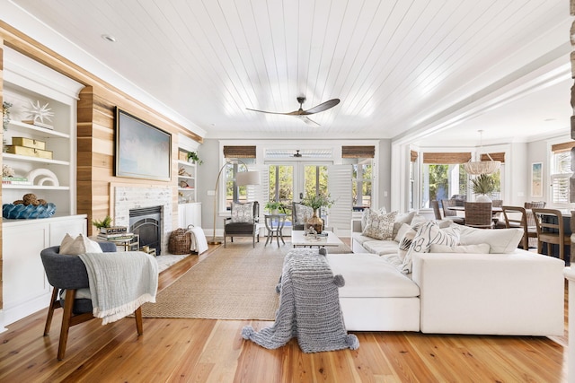 1635 Bull Creek Ln, Charleston, SC 29414 - living area with a ceiling fan, a fireplace, light wood finished floors, built in features, and crown molding