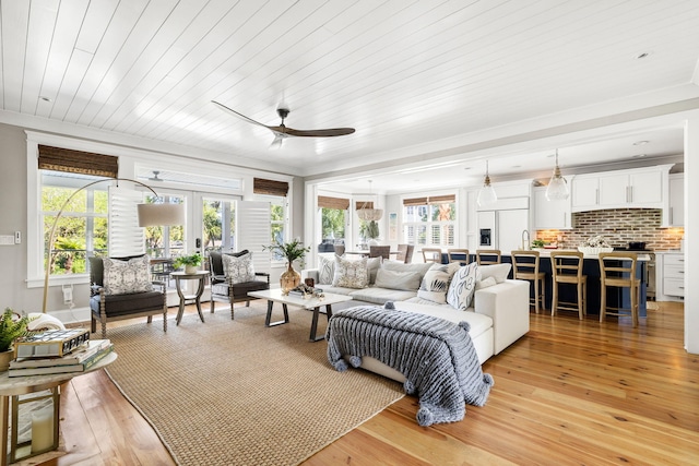 1635 Bull Creek Ln, Charleston, SC 29414 - living area featuring light wood-style flooring, ceiling fan, plenty of natural light, french doors, and ornamental molding