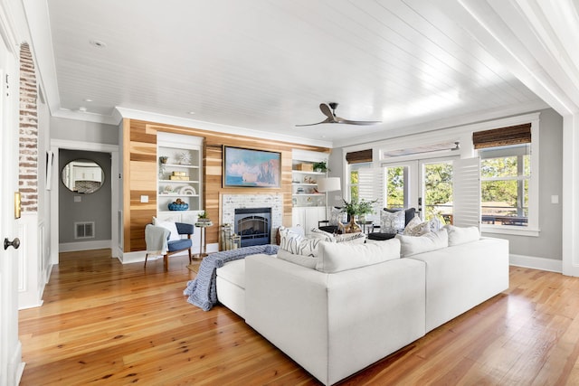 1635 Bull Creek Ln, Charleston, SC 29414 - living area with a ceiling fan, baseboards, a tiled fireplace, light wood-style floors, and crown molding
