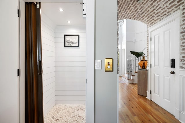 1635 Bull Creek Ln, Charleston, SC 29414 - hallway with elevator, wood finished floors, wooden walls, and brick ceiling