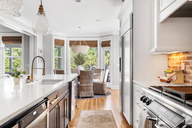 1635 Bull Creek Ln, Charleston, SC 29414 - kitchen featuring a sink, stainless steel range, light wood finished floors, and hanging light fixtures