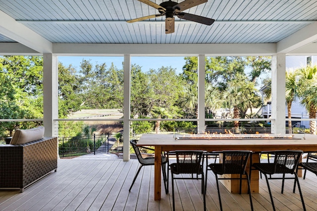 1635 Bull Creek Ln, Charleston, SC 29414 - sunroom featuring ceiling fan, beam ceiling, view of wooded area, and outdoor dining area