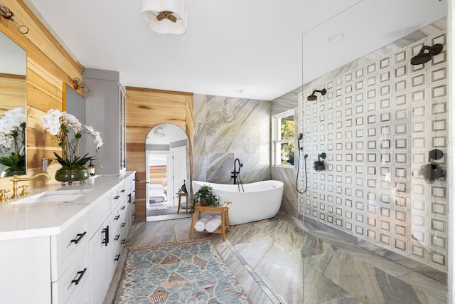 1635 Bull Creek Ln, Charleston, SC 29414 - full bathroom with vanity, a walk in shower, a soaking tub, marble finish flooring, and wooden walls