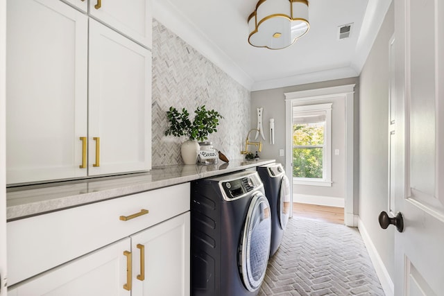 1635 Bull Creek Ln, Charleston, SC 29414 - laundry room featuring washer and dryer, cabinet space, brick floors, baseboards, and ornamental molding