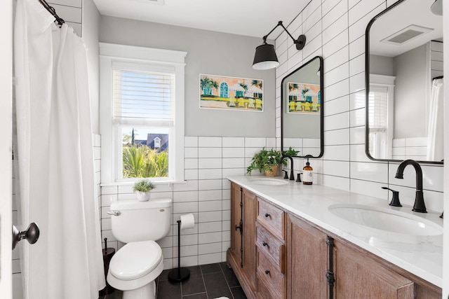 1635 Bull Creek Ln, Charleston, SC 29414 - full bath with tile walls, tile patterned floors, double vanity, toilet, and a wainscoted wall
