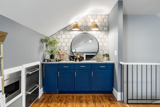 1635 Bull Creek Ln, Charleston, SC 29414 - bar with lofted ceiling, decorative backsplash, stainless steel microwave, dark wood-style flooring, and a warming drawer