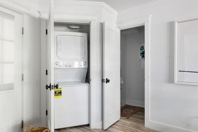 1635 Bull Creek Ln, Charleston, SC 29414 - laundry area with stacked washer and clothes dryer, light wood finished floors, baseboards, and ornamental molding