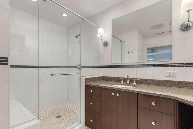 bathroom with vanity and a shower with door