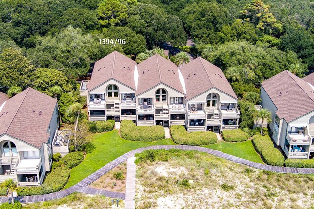 birds eye view of property featuring a water view and a view of the beach