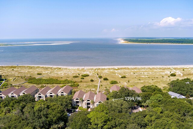 birds eye view of property with a view of the beach and a water view