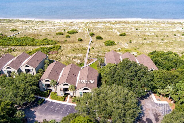 bird's eye view with a water view and a beach view