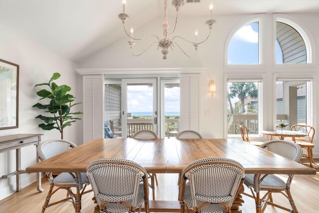 dining area with a chandelier, light hardwood / wood-style floors, and a wealth of natural light