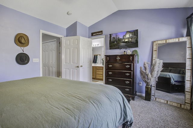 bedroom with lofted ceiling, ensuite bath, and carpet