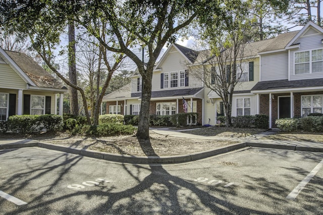 multi unit property featuring brick siding and a residential view