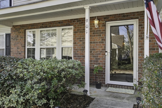 property entrance with brick siding