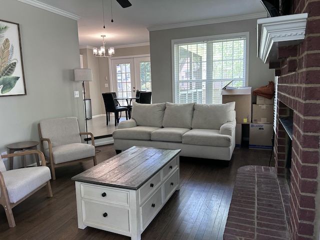 8701 Caspiana Ln, North Charleston, SC 29420 - living area with dark wood-style flooring, a brick fireplace, ornamental molding, a chandelier, and ceiling fan