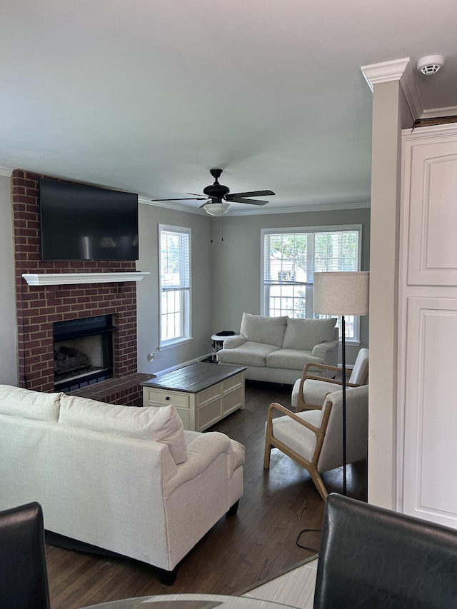 8701 Caspiana Ln, North Charleston, SC 29420 - living room featuring ornamental molding, dark wood-style flooring, ceiling fan, and a brick fireplace