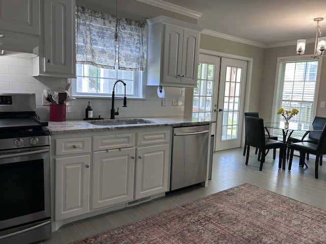 8701 Caspiana Ln, North Charleston, SC 29420 - kitchen with stainless steel appliances, a chandelier, healthy amount of natural light, and crown molding