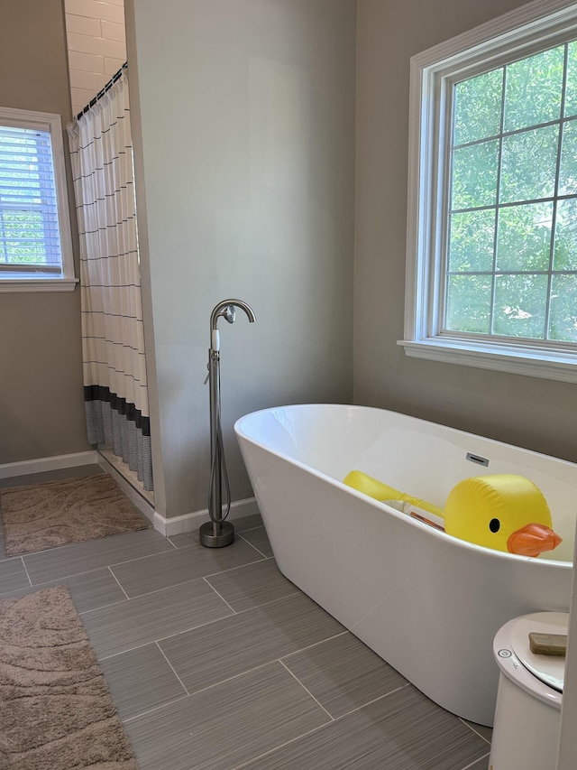 8701 Caspiana Ln, North Charleston, SC 29420 - full bathroom with a freestanding bath, tile patterned flooring, and a shower with curtain