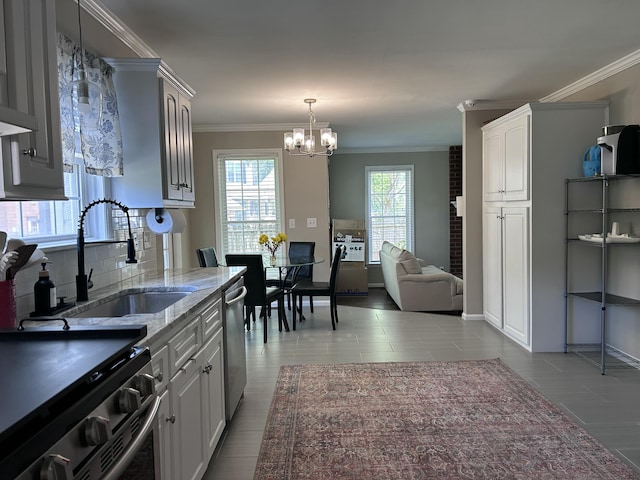 8701 Caspiana Ln, North Charleston, SC 29420 - kitchen featuring range, a chandelier, stainless steel dishwasher, crown molding, and light stone counters