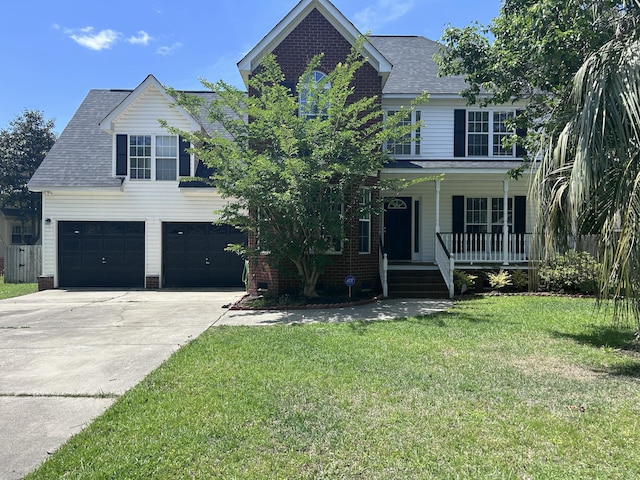 8701 Caspiana Ln, North Charleston, SC 29420 - traditional home with an attached garage, a porch, concrete driveway, a front lawn, and a shingled roof
