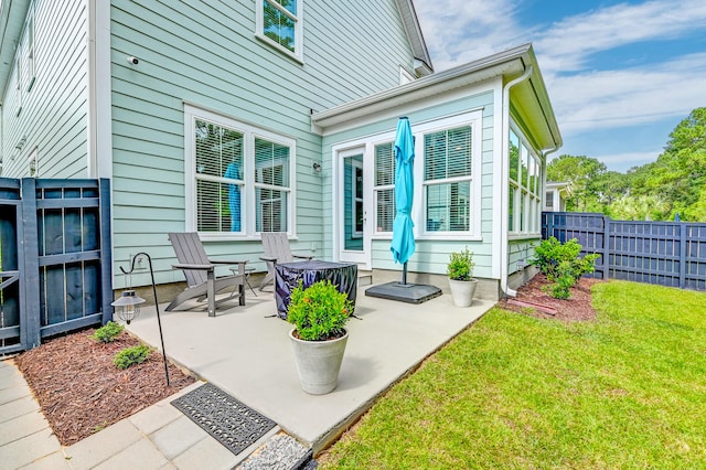 rear view of house with a yard and a patio