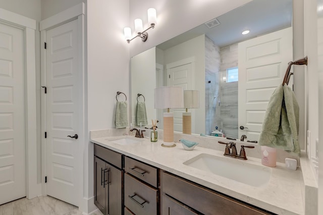 bathroom with vanity and a shower with shower door