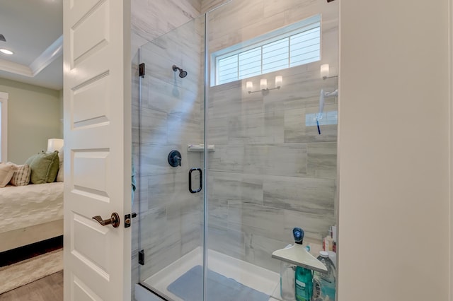 bathroom featuring wood-type flooring and a shower with door