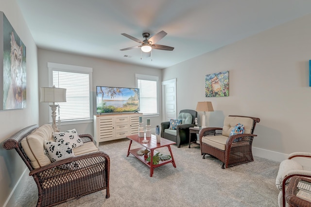 carpeted living room featuring ceiling fan and plenty of natural light