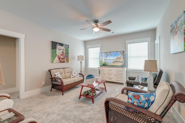 carpeted living room with ceiling fan