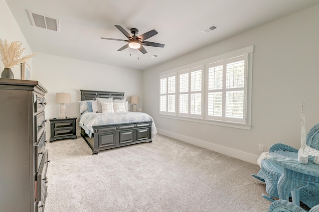 bedroom with ceiling fan and light colored carpet