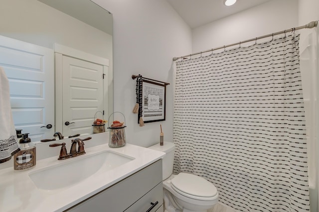 bathroom with vanity, toilet, and walk in shower