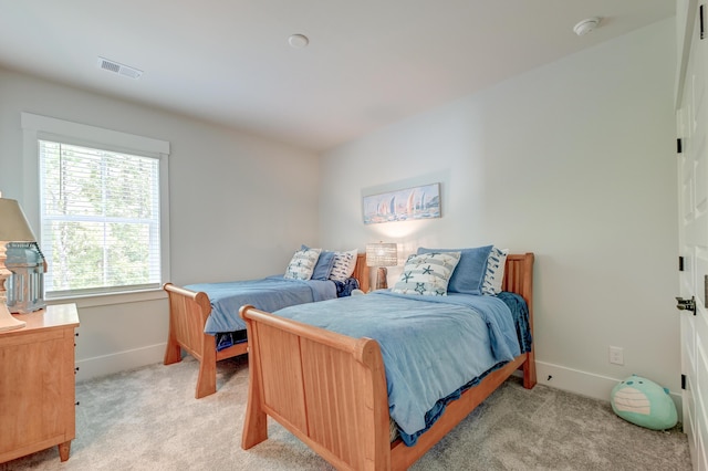 bedroom featuring light carpet