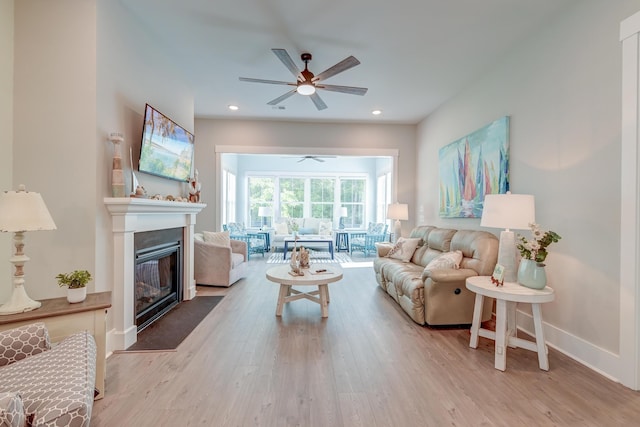 living room featuring light hardwood / wood-style floors and ceiling fan