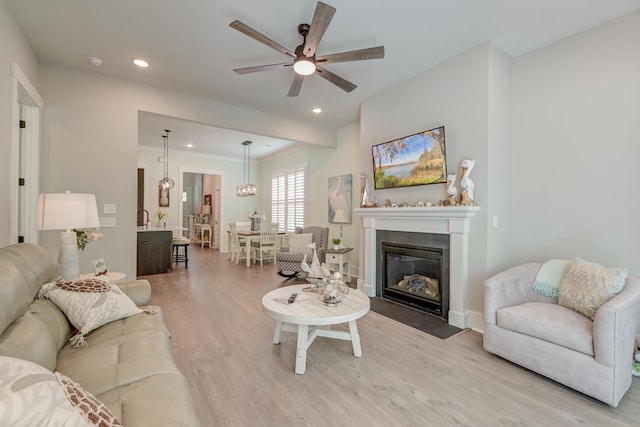 living room featuring light hardwood / wood-style floors and ceiling fan