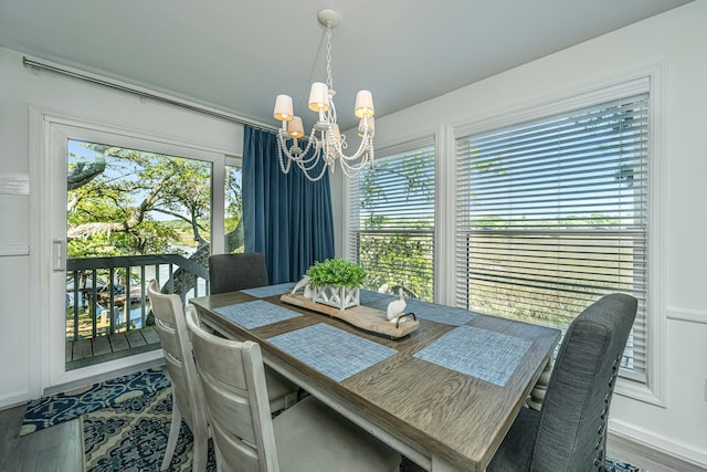 dining space featuring plenty of natural light, hardwood / wood-style floors, and a chandelier