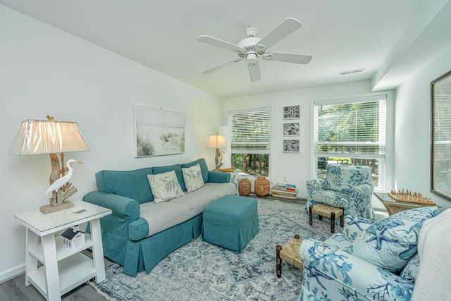 living room featuring wood-type flooring and ceiling fan