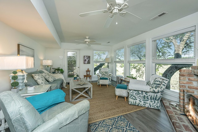 living room with wood-type flooring and ceiling fan