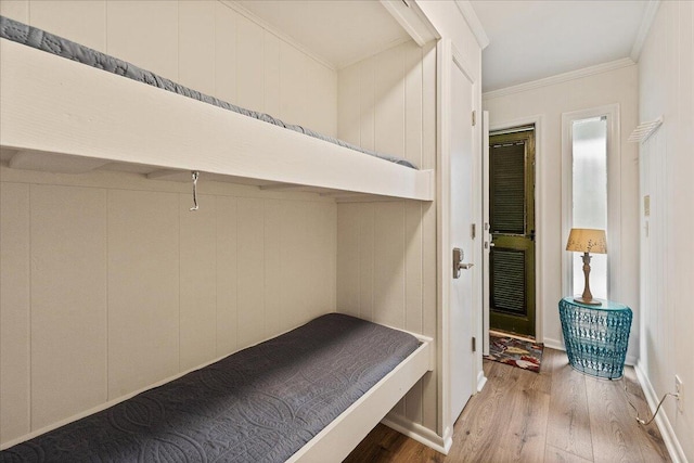 interior space with ornamental molding and hardwood / wood-style floors