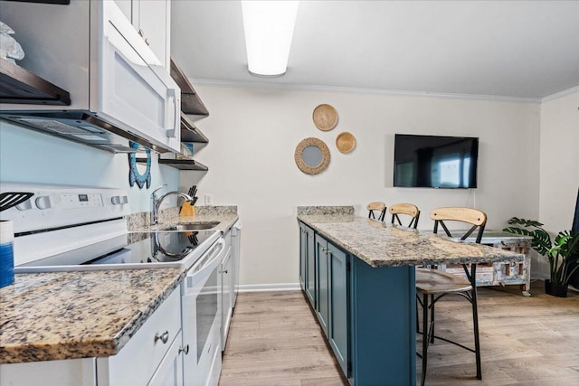 kitchen with a breakfast bar, light hardwood / wood-style floors, electric range, white cabinetry, and blue cabinetry