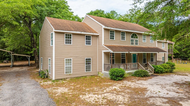 312 Piney Grove Rd, Cross, SC 29436 - view of front of home with covered porch, a detached carport, driveway, and a shingled roof