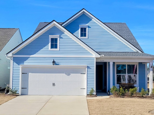 view of front facade featuring a garage, concrete driveway, and a shingled roof