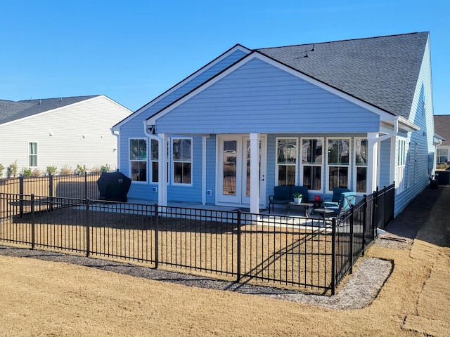 view of front facade featuring fence private yard and a shingled roof