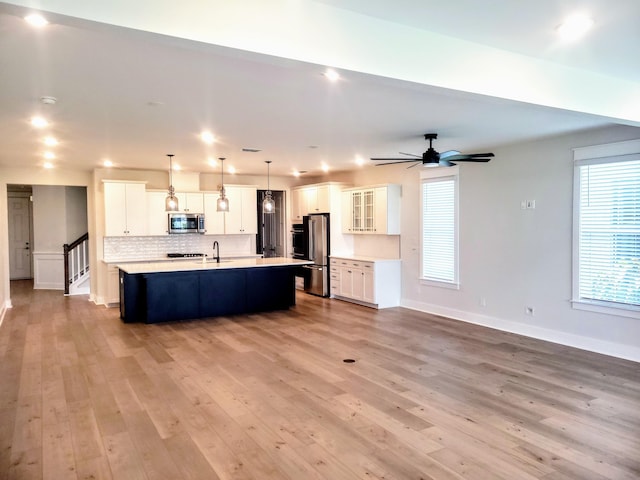 123 Leeward Lndg, Summerville, SC 29486 - kitchen featuring stainless steel appliances, light wood-style floors, an island with sink, and light countertops
