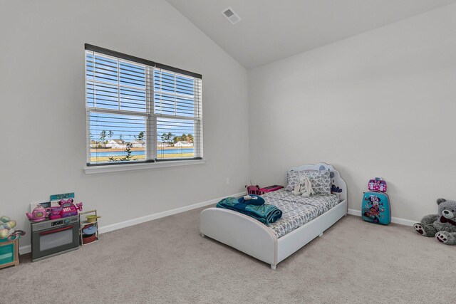 bedroom with vaulted ceiling, carpet, and baseboards