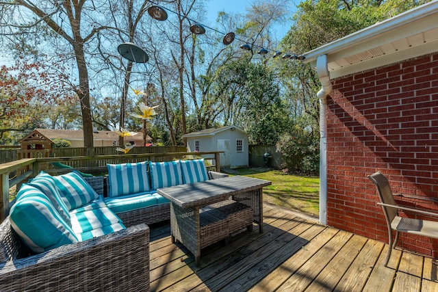 deck with an outdoor living space, an outdoor structure, a shed, and fence