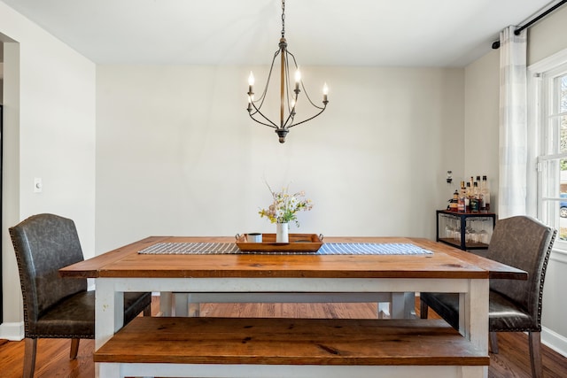 dining room featuring wood finished floors and a chandelier