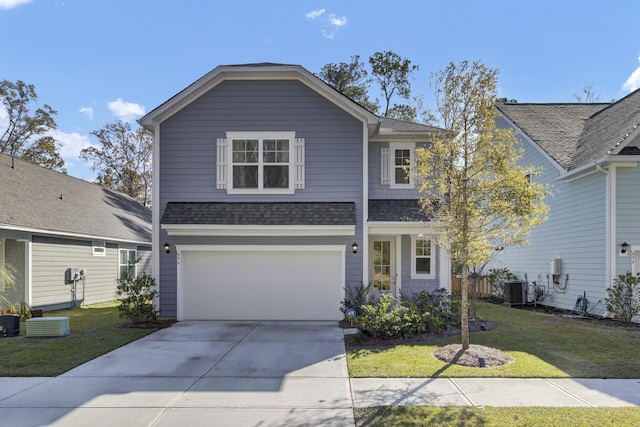 front of property featuring central AC unit, a garage, and a front yard