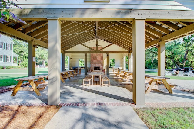 view of patio / terrace with a gazebo and an outdoor brick fireplace