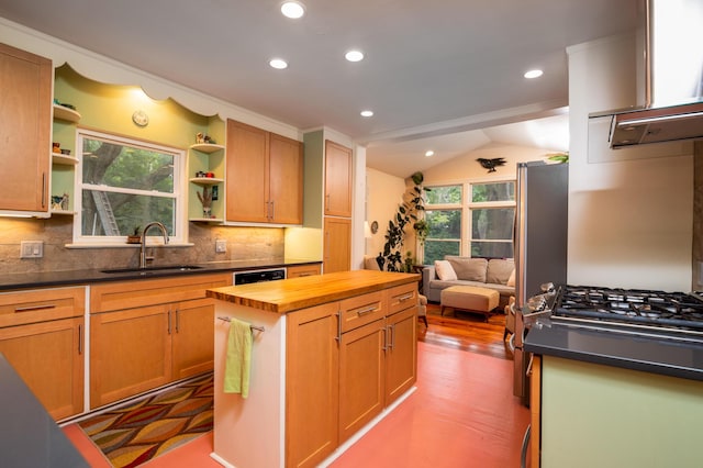 kitchen with butcher block counters, open shelves, a sink, lofted ceiling, and decorative backsplash